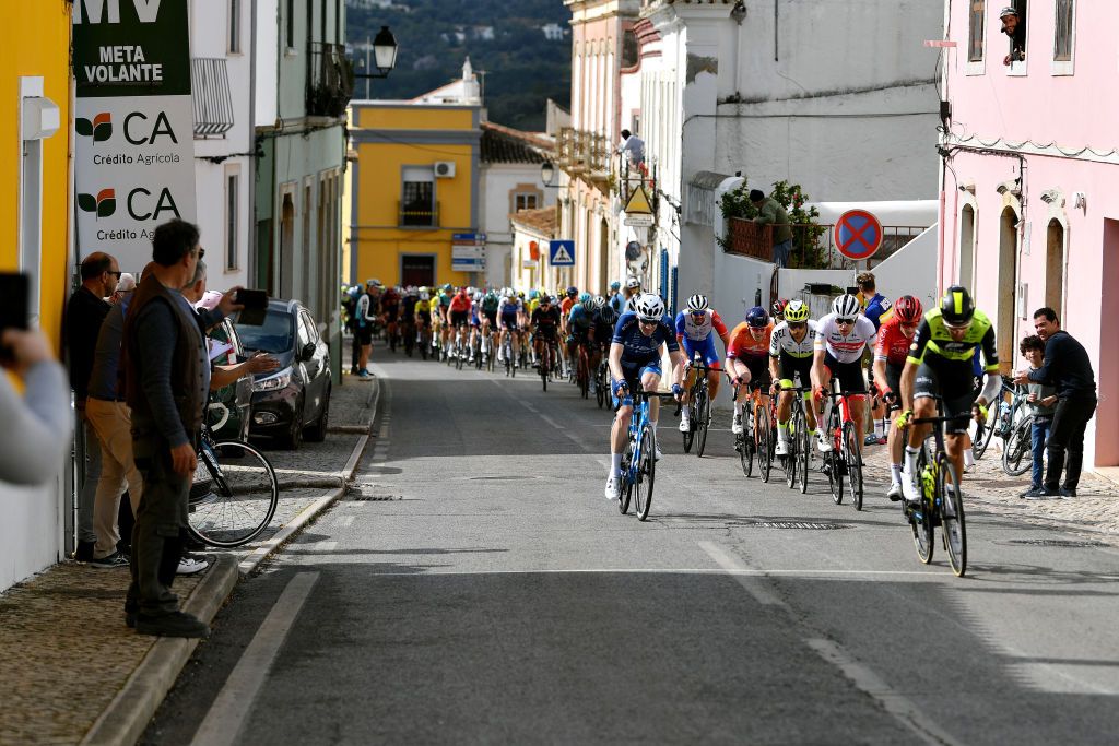 LOULE PORTUGAL FEBRUARY 20 A general view of the peloton passing through village landscape during the 48th Volta Ao Algarve 2022 Stage 5 a 173km stage from Lagoa to MalhoLoul 514m VAlgarve2022 on February 20 2022 in Loule Portugal Photo by Luc ClaessenGetty Images
