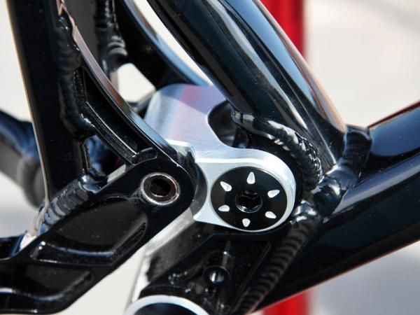 The revised lower link is made of machined aluminum.