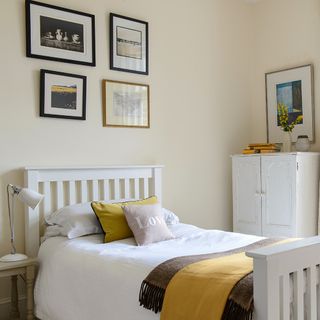 bedroom photo frames on off white walls and white cupboard