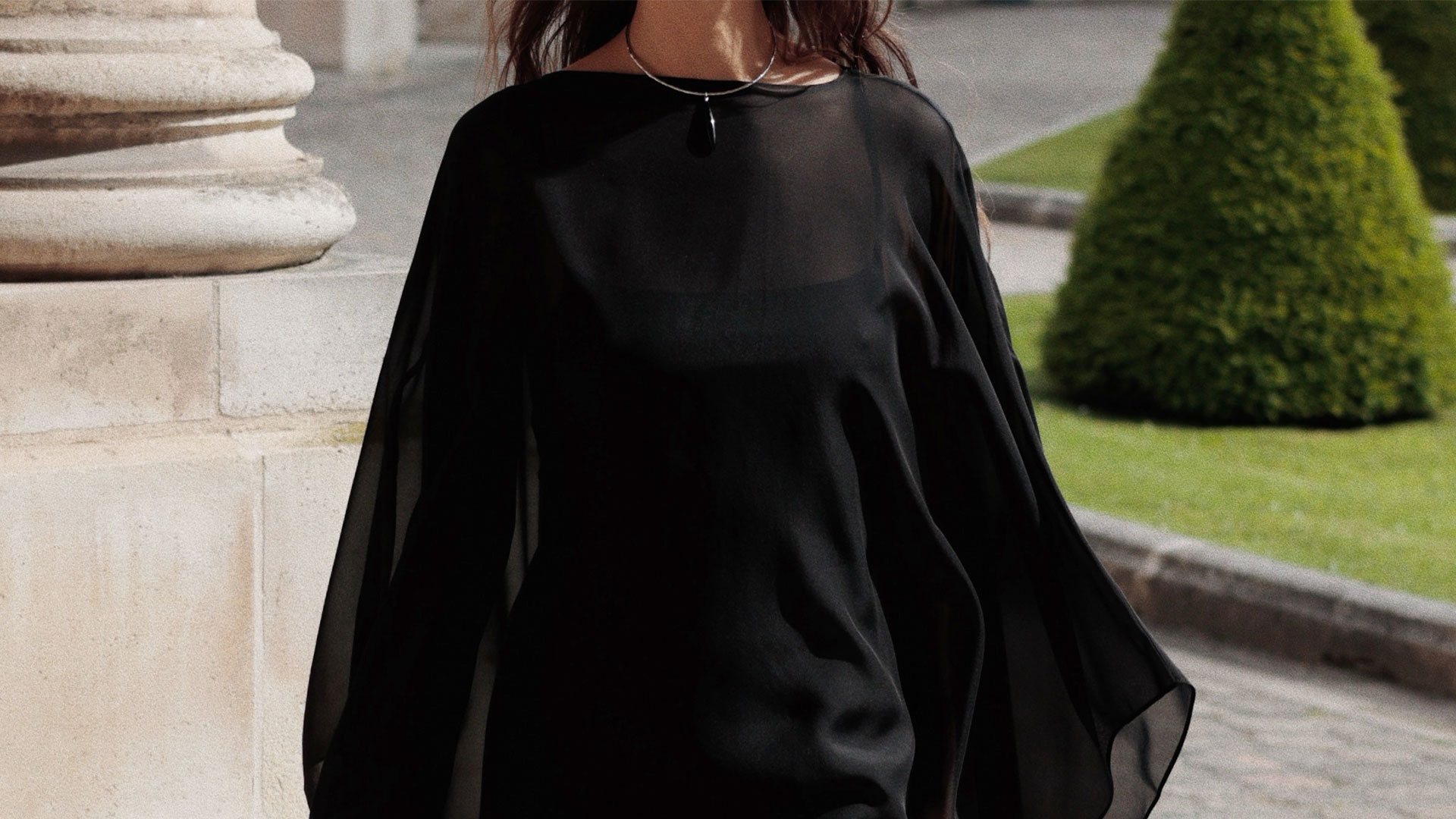 @modedamour wearing a black chiffon sheer cape top