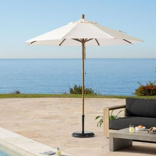 A white standing outdoor umbrella from West Elm