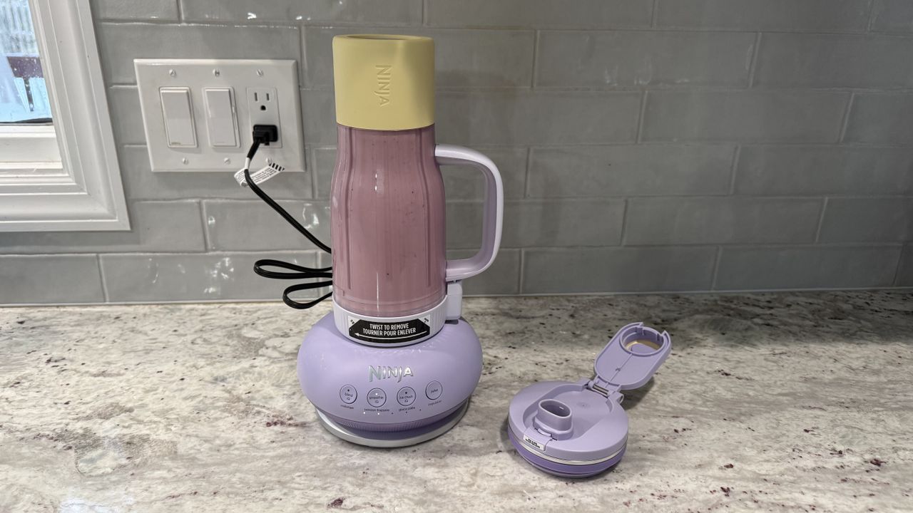 Ninja BlendBOSS&trade; Tumbler Blender with 26oz Travel Tumbler making a cherry smoothie