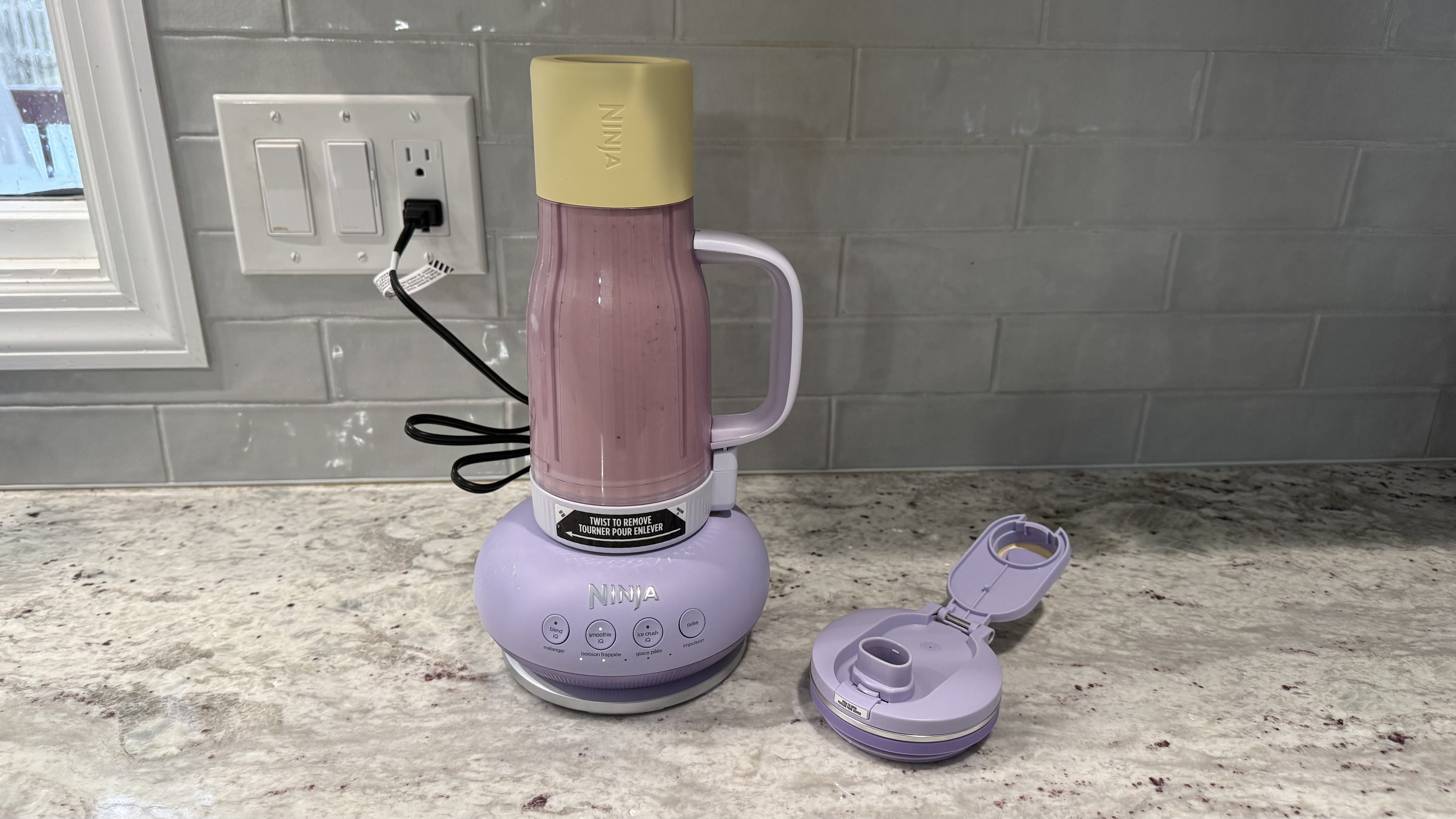 Ninja BlendBOSS&trade; Tumbler Blender with 26oz Travel Tumbler making a cherry smoothie