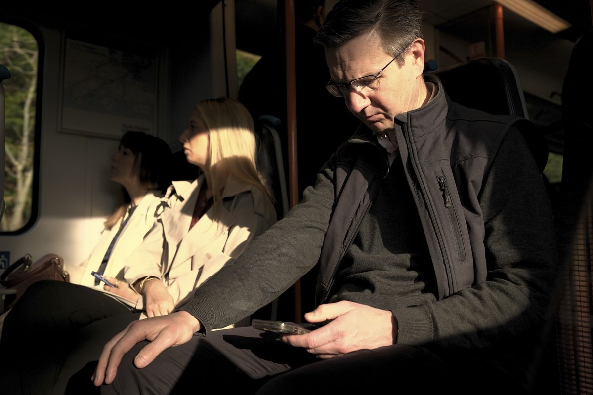 Commuter on early morning train, texting, taken with the Sigma BF camera and Sigma 35mm F2 DG lens