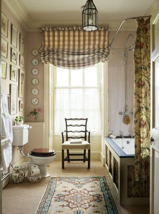Country bathroom with gingham blind, cream walls and gallery wall