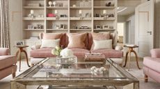neutral and peach drawing room with bespoke wall of shelving and glass coffee to highlight the need to know how to reduce dust for easier cleaning