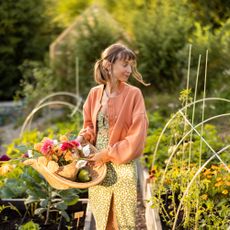 Young woman in raised bed garden