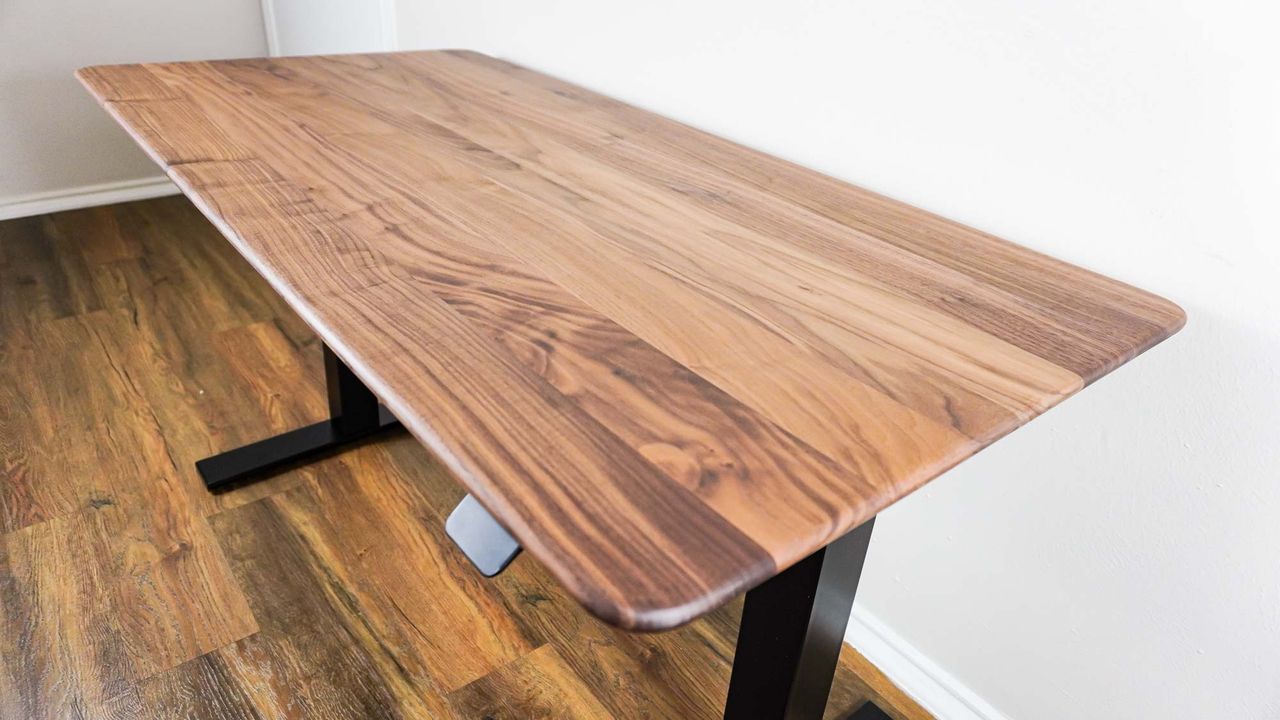 An angled view of the Oakywood Standing Desk Pro's handmade wooden desk top