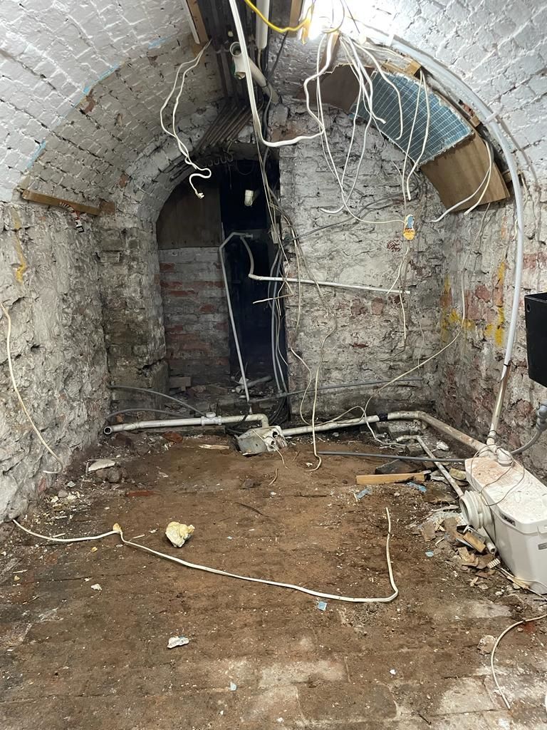The bare walls in the air raid shelter before the bathroom was added