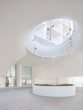 Jade Signature residential tower bright and sculptural white lobby