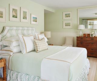 bedroom with pale green walls and gingham cushions