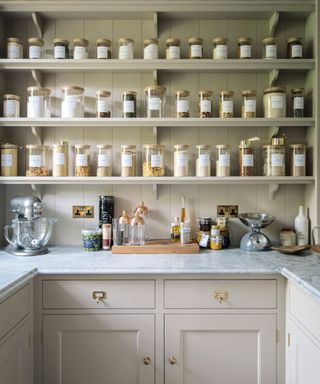 neutral walk in pantry with matching glass jars