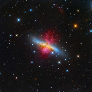 "About 12 million light years away from our planet, lays the starburst galaxy M82, also known as the Cigar Galaxy. In a show of radiant red, the superwind bursts out from the galaxy, believed to be the closest place to our planet in which the conditions are similar to that of the early Universe, where a plethora of stars are forming."