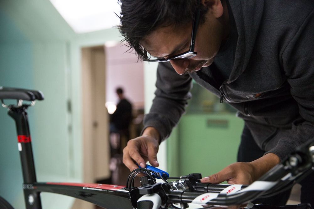 Rally Cycling mechanic Erik Maresjo makes adjustments to the armrests on Adam De Vos&rsquo;s Hed Corsair aerobars.