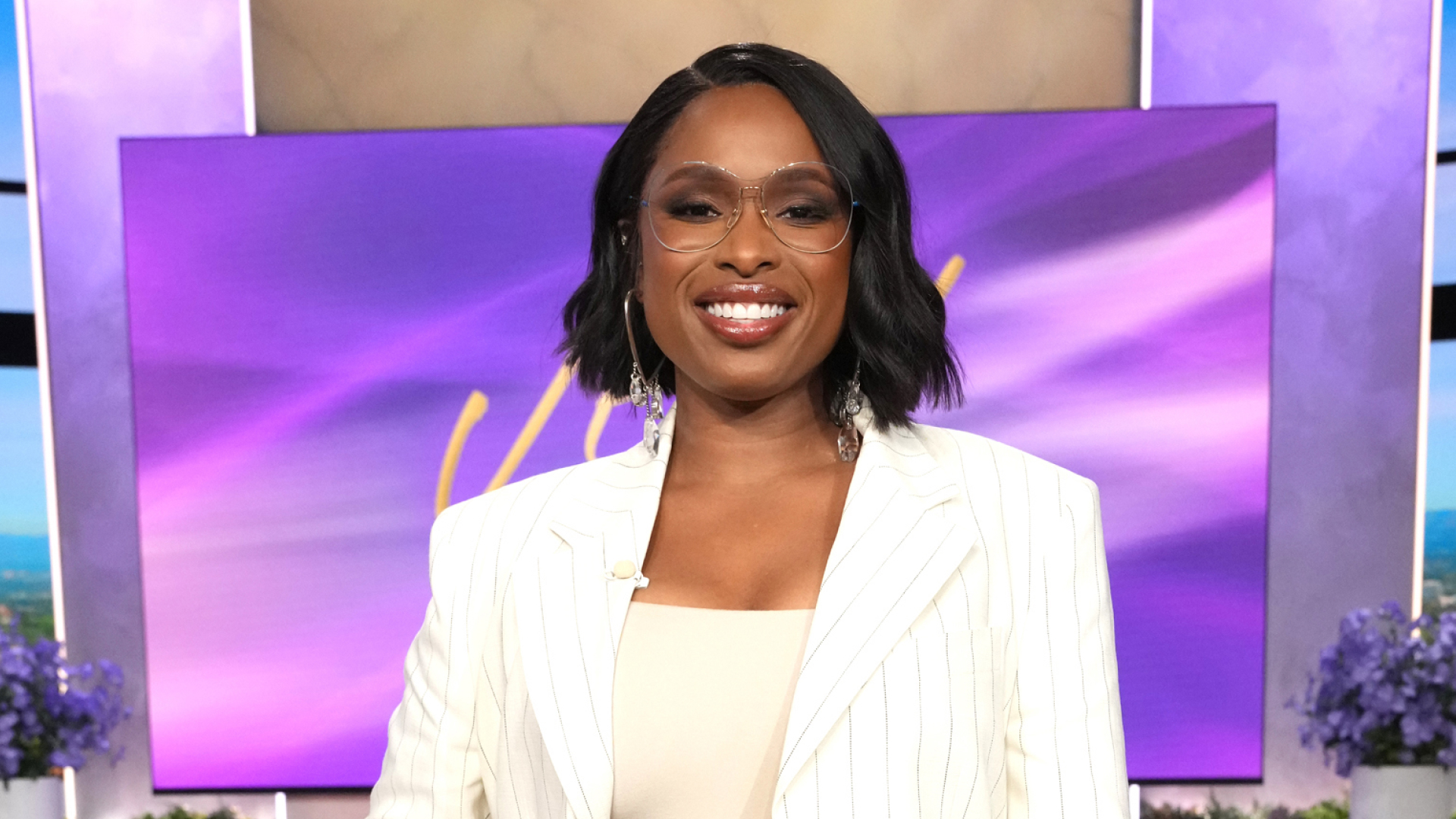 Jennifer Hudson wearing a bob haircut a white striped blazer