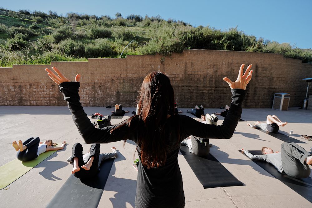 The riders get some yoga training.