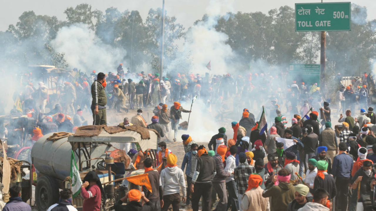 Protesters are pictured being targeted with tear gas