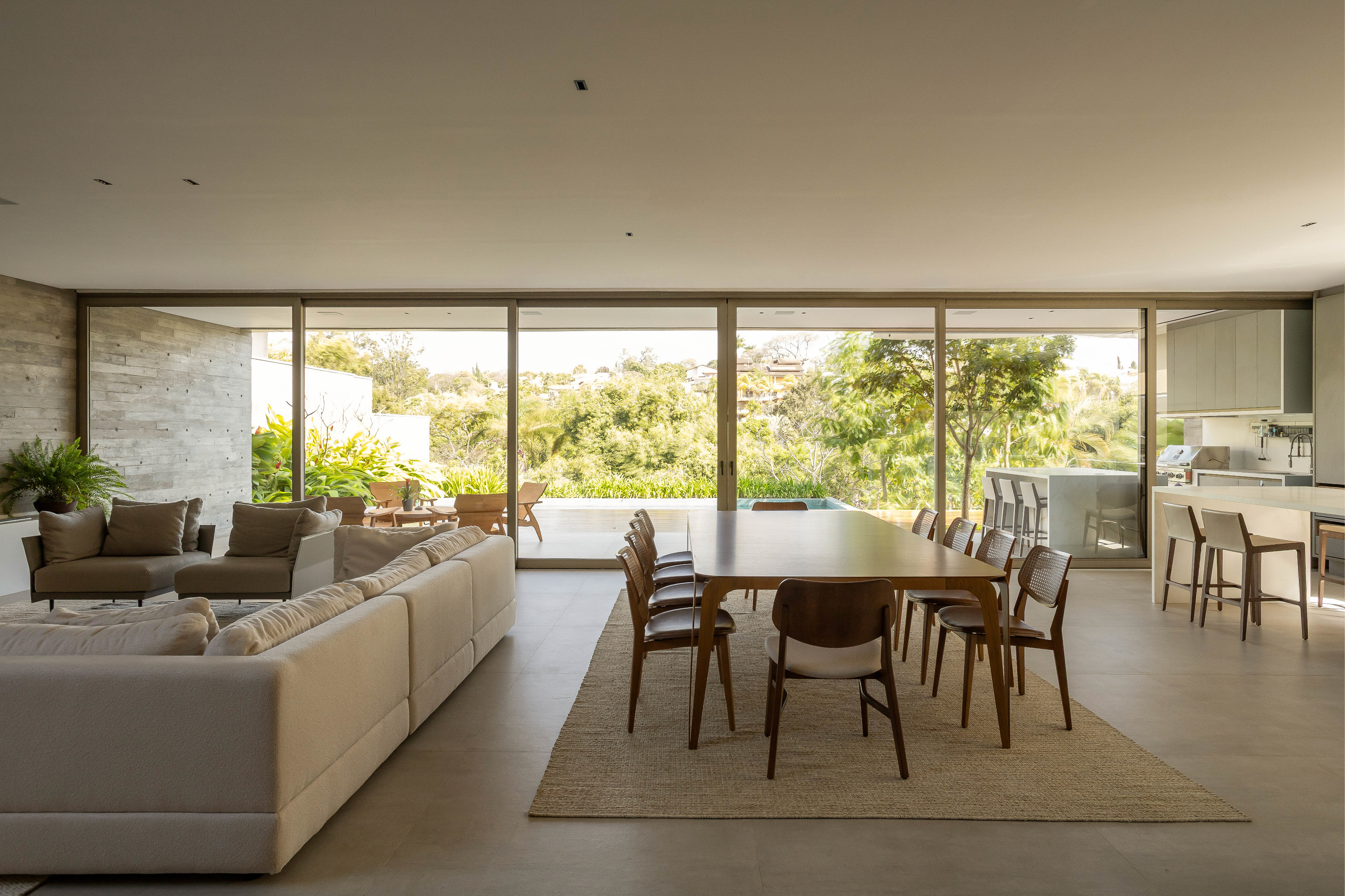 The main living space overlooks a covered patio with the pool and landscape beyond