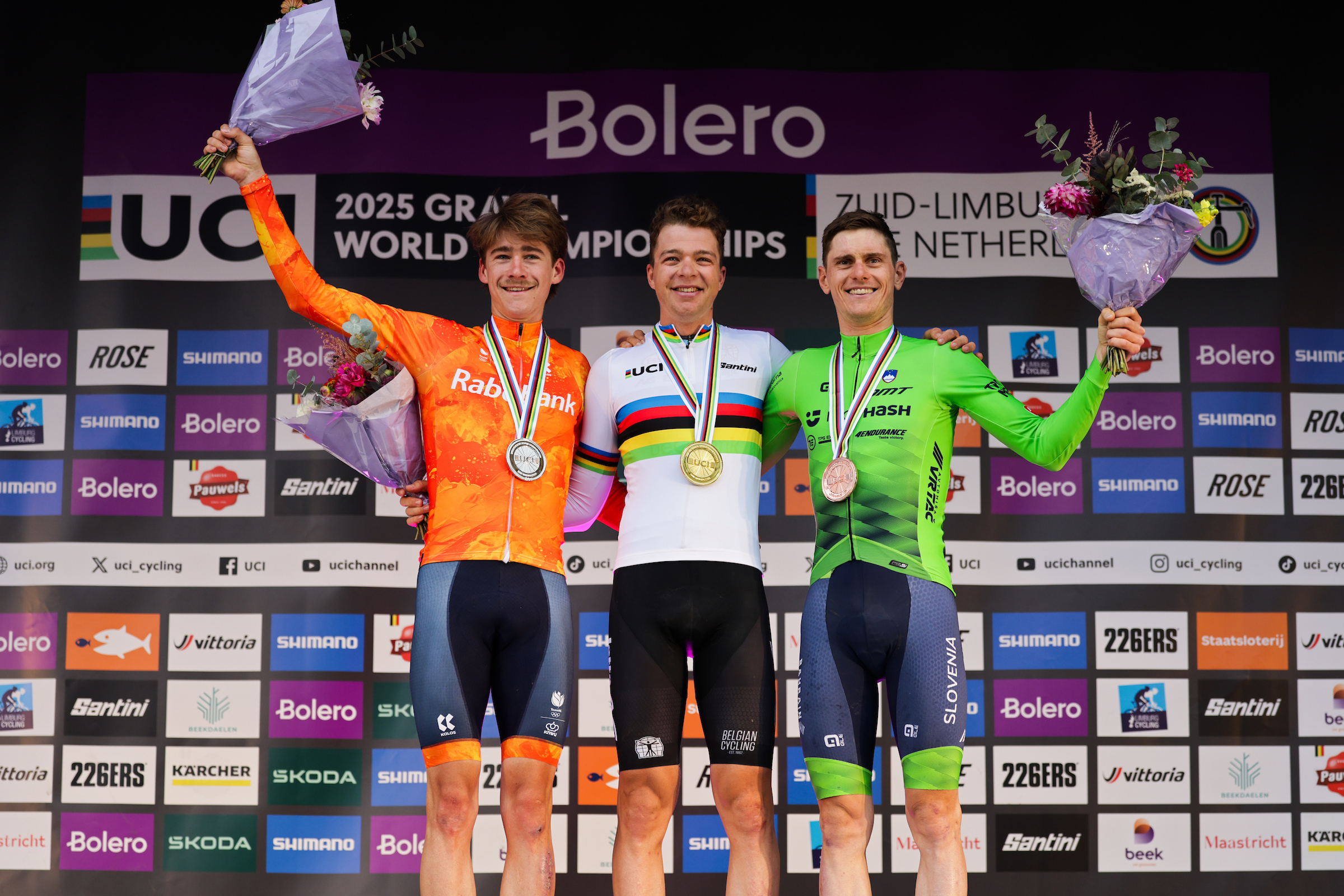 Picture by Alex Whitehead/SWpix.com - 12/10/2025 - Cycling - 2025 UCI Gravel World Championships, Zuid-Limburg, Netherlands - Men Elite Race Podium - Florian Vermeersch (Belgium) receiving the Gold Medal to become World Champion with Frits Biesterbos (Netherlands) receiving the Silver Medal and Matej Mohoric (Slovenia) receiving the Bronze Medal