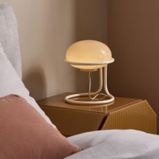 MADE's Piper Table Lamp in Cream on a bedside table