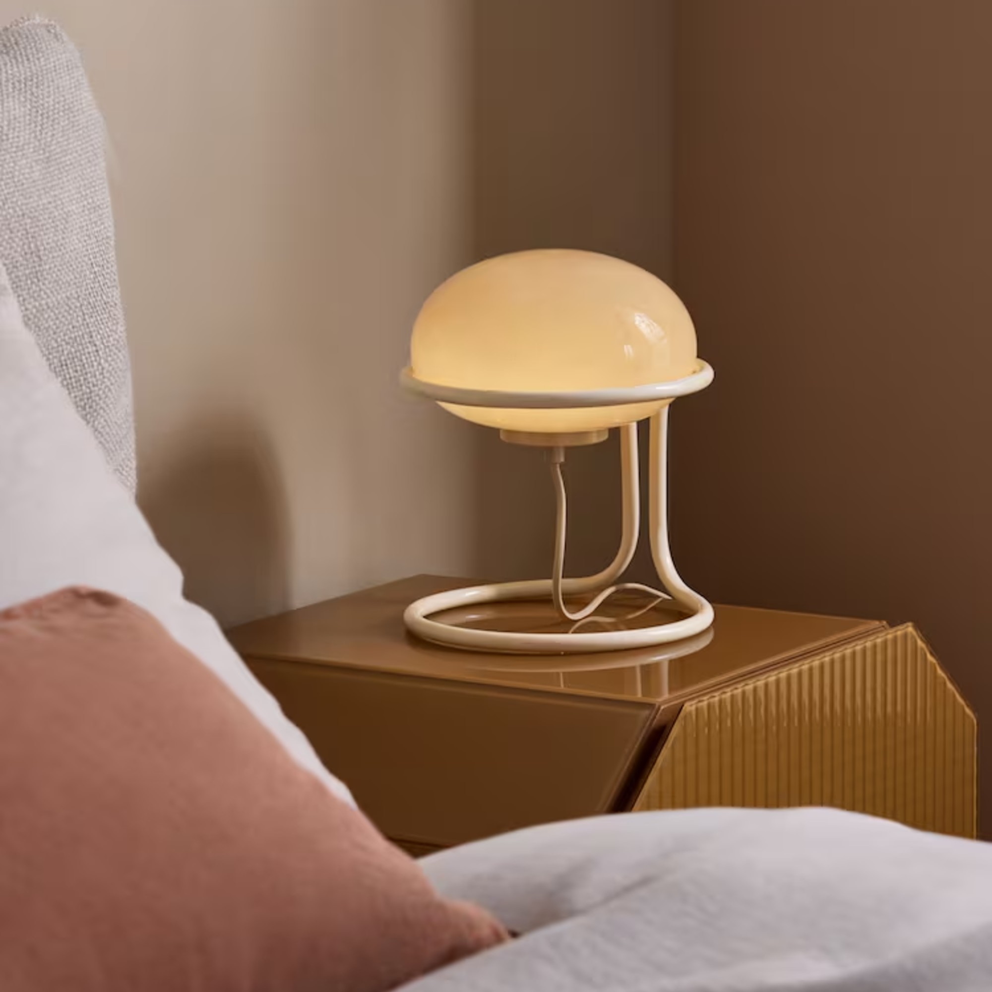 MADE's Piper Table Lamp in Cream on a bedside table