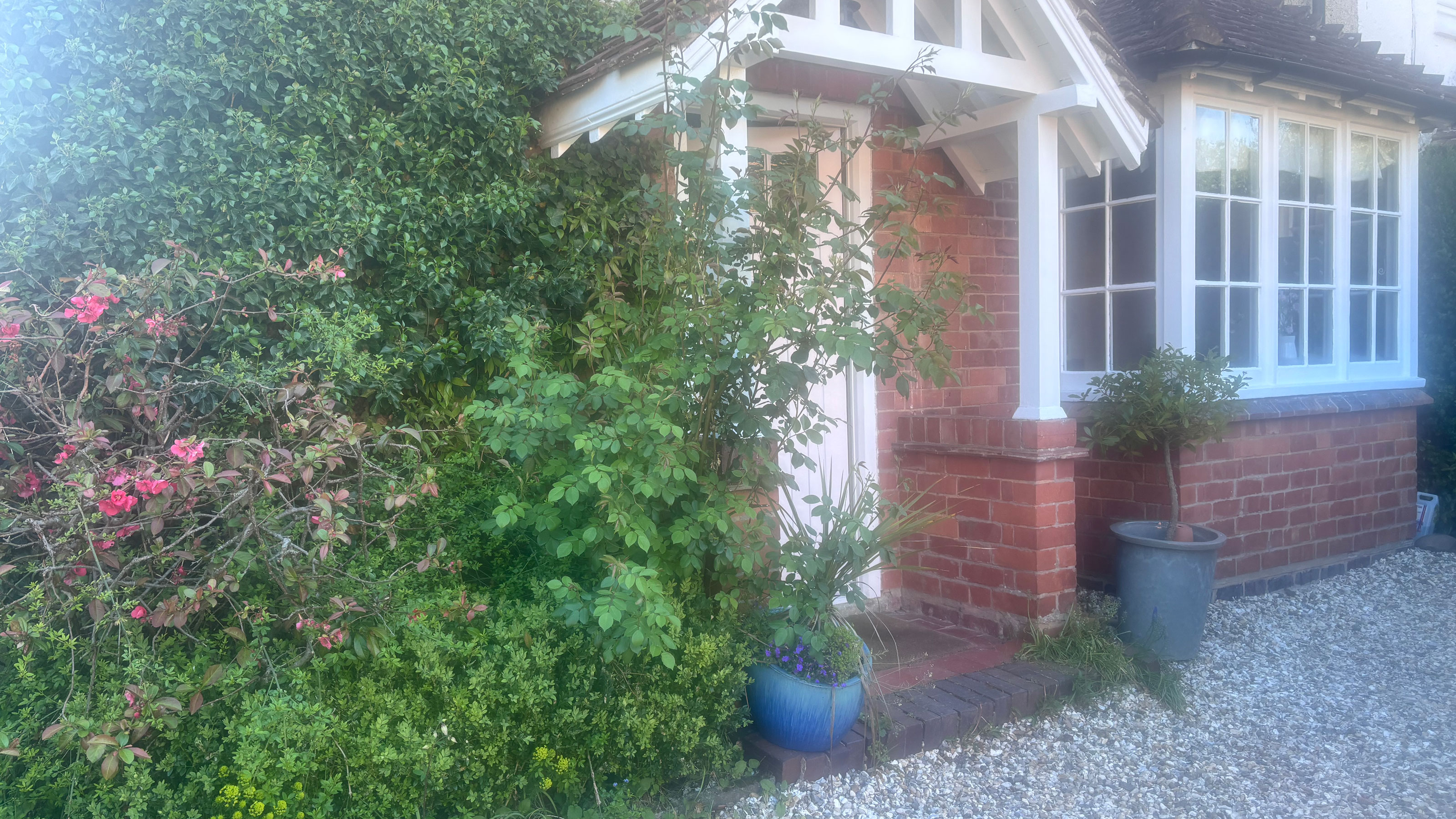 front of old house with white porch and bay window
