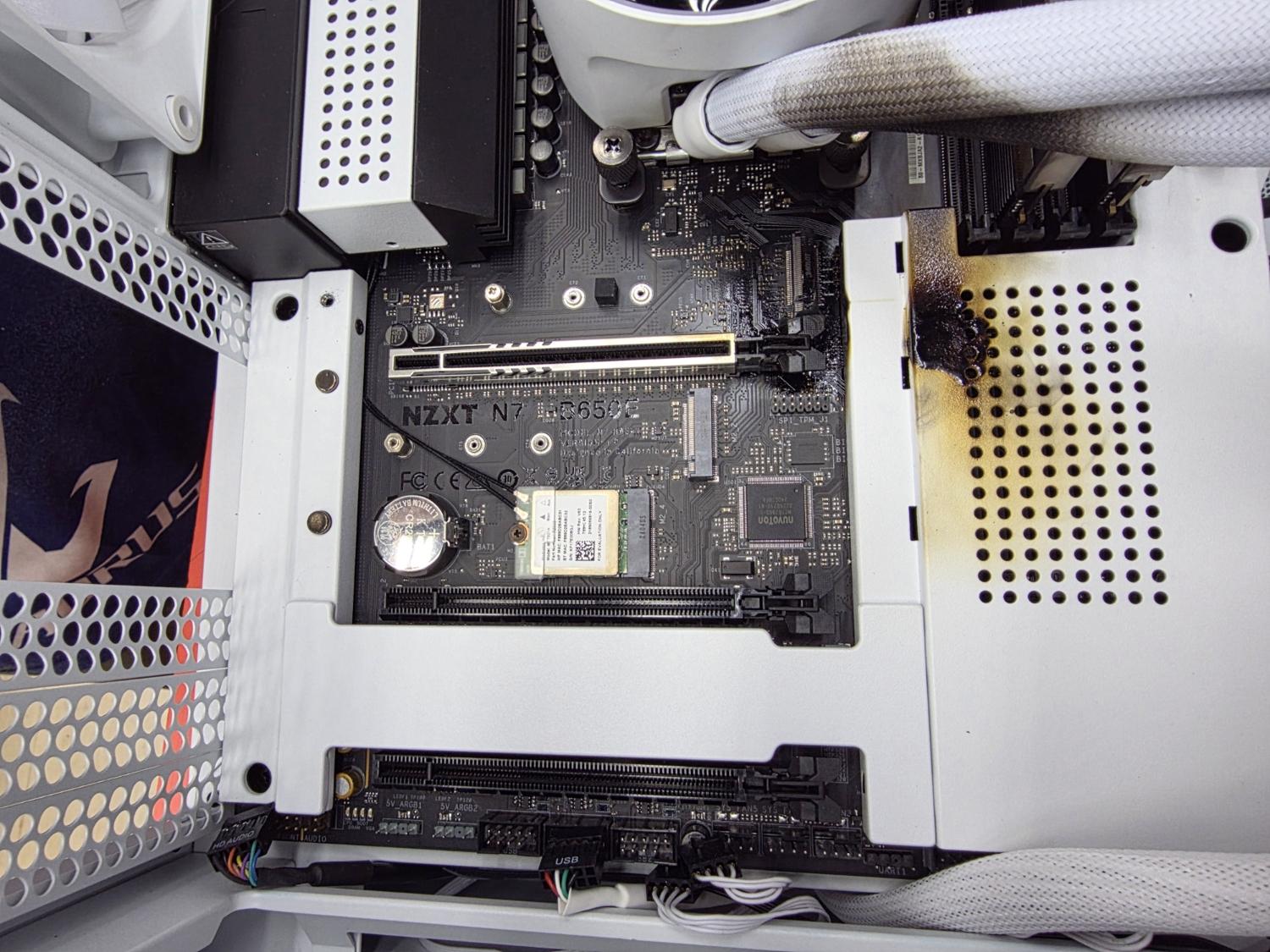 An RTX 5090 that caught fire and also left burnt marks on the motherboard, AIO cooler and RAM