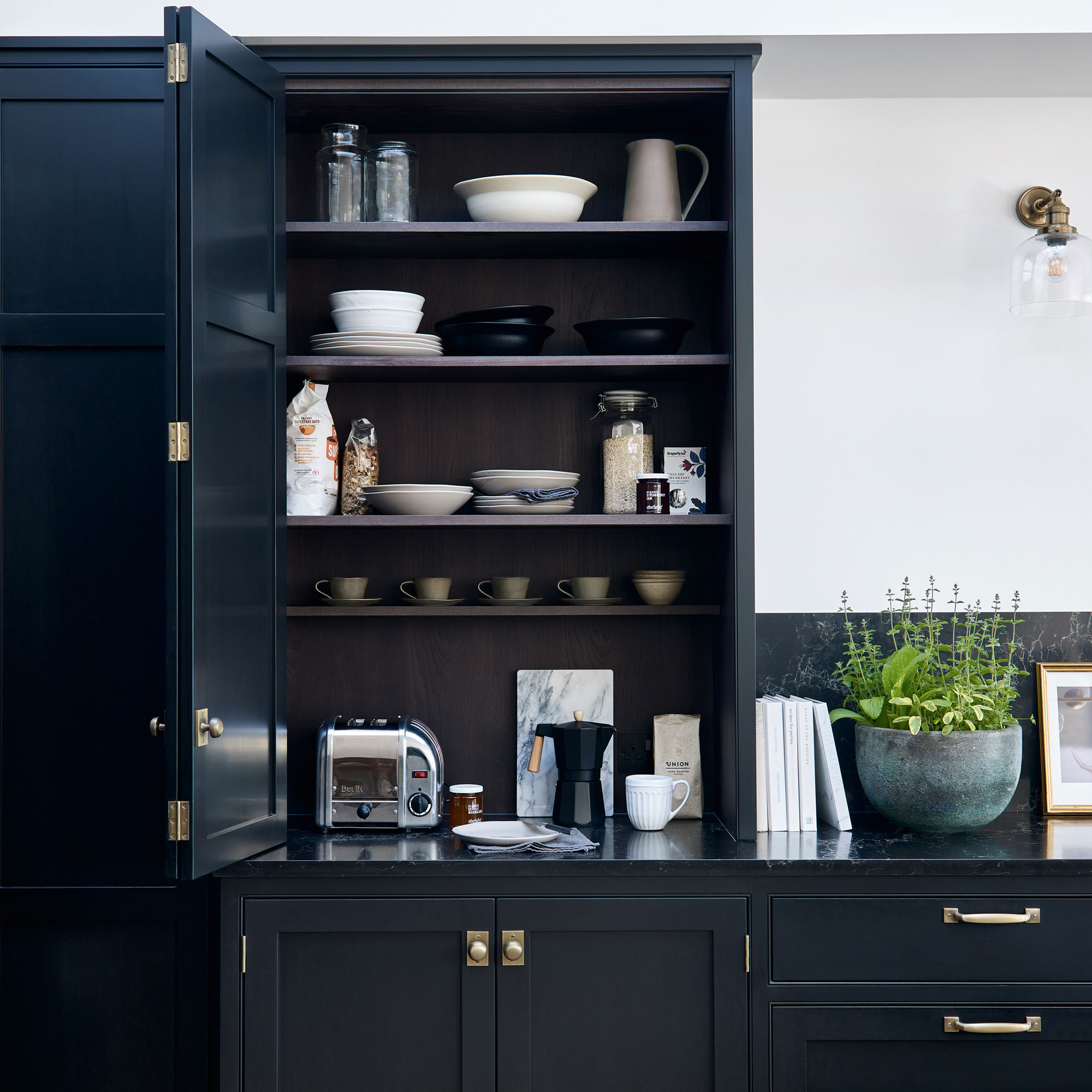 Black kitchen with cabinet open