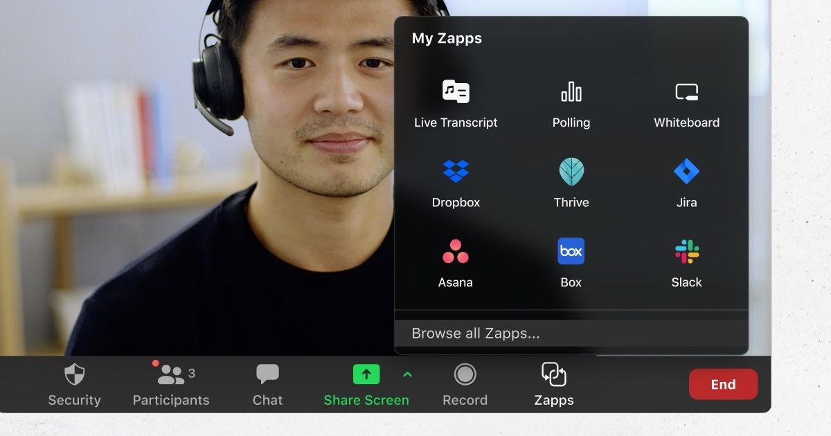 A smiling young man using Zoom&amp;#039;s new apps while on a video call