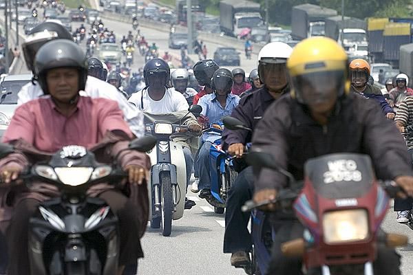 A Malaysian scooter army was hot on our heels after we stopped for a photo opportunity on the freeway into Kuala Lumpur.