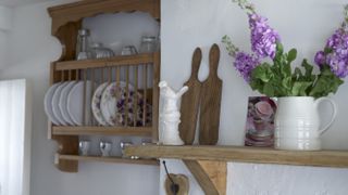 Cute details in kitchen wooden and ceramic decor and sweetpeas