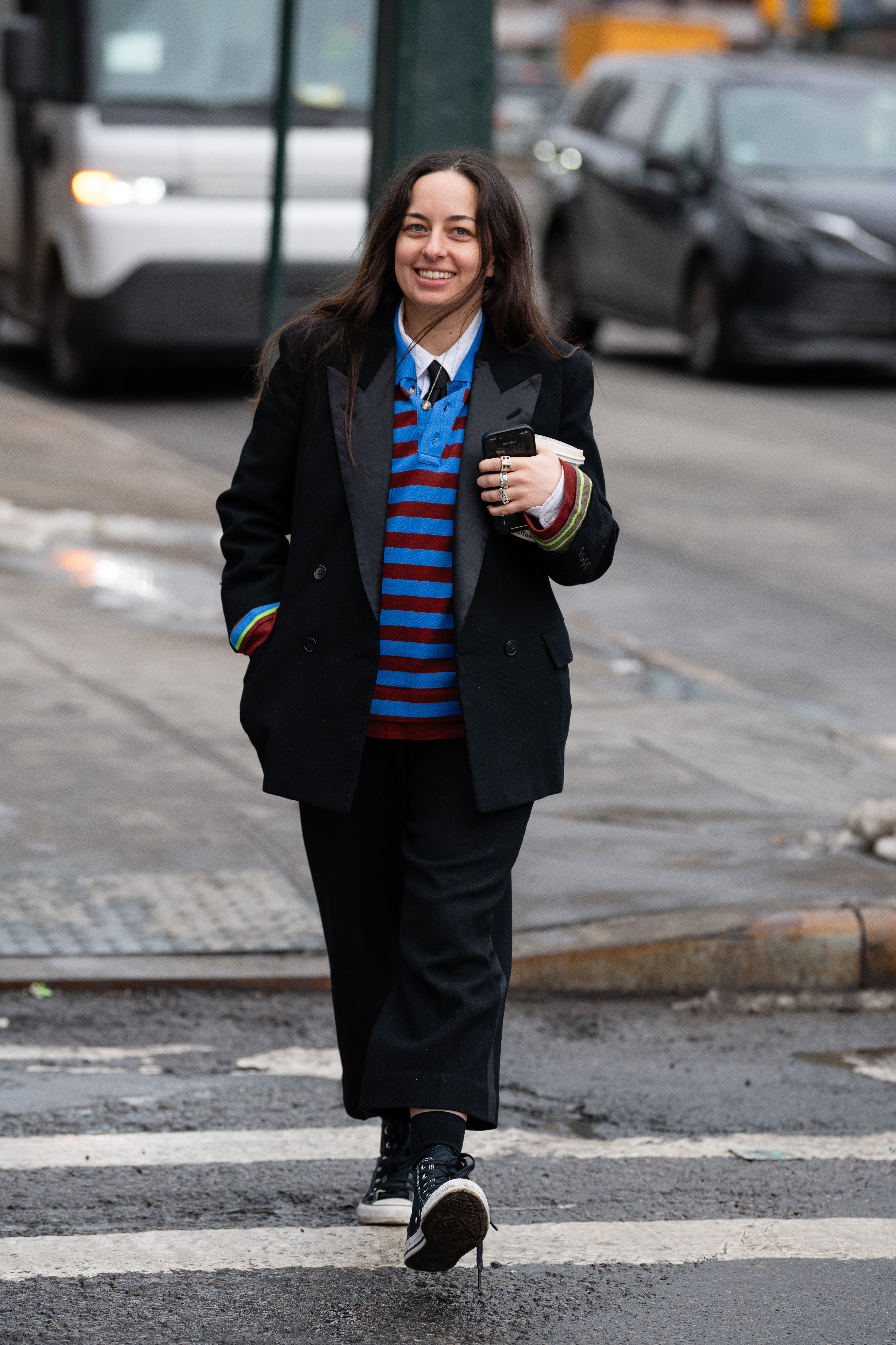 woman wearing striped shirt, blazer, jeans, a necktie,and shoes
