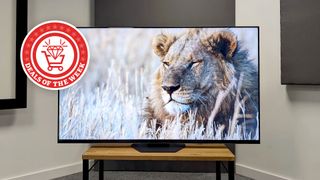 Hisense Mini LED on a TV stand with a Deals of the Week logo superimposed