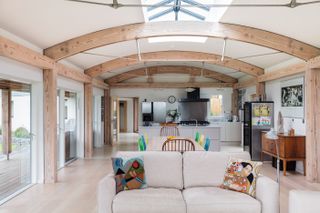 open plan kitchen and living area with curved vaulted ceiling