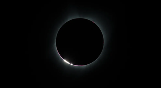 view of a solar eclipse against a dark sky.