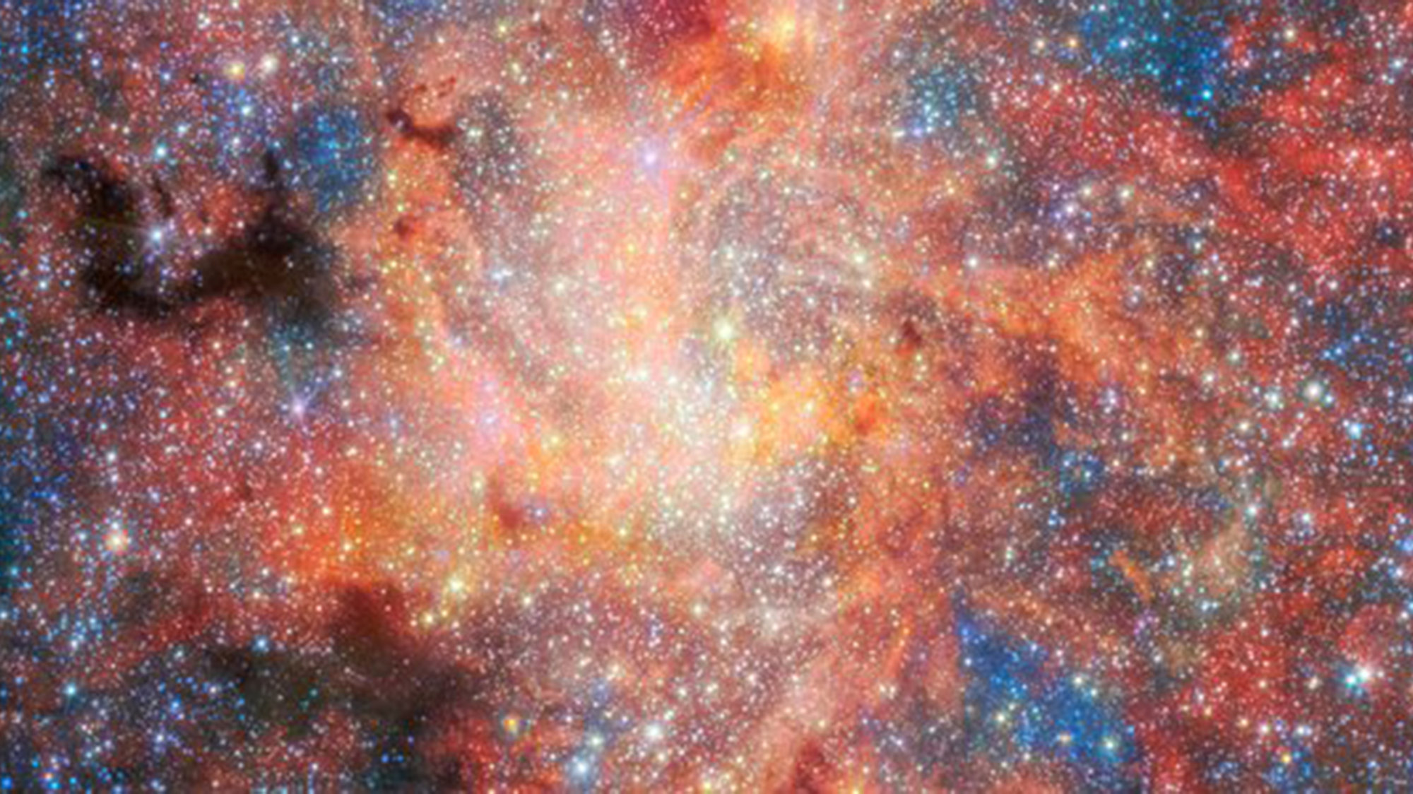 Red and blue gas swirl amidst glowing stars in deep space