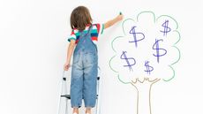 Child on ladder and chalk money tree drawing on living room wall