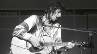 Keith Richards playing an acoustic guitar