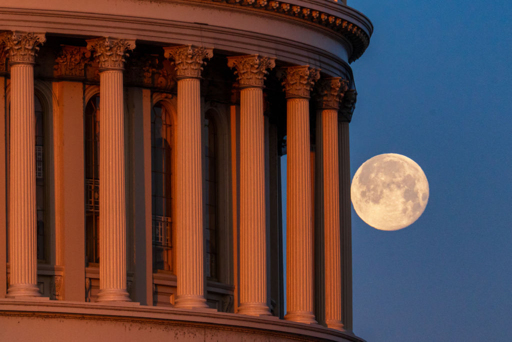 Photo of the full moon behind the pillars US Capitol Dome on February 25, 2024, in Washington, DC.