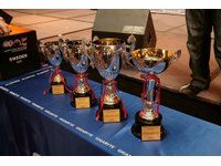 Four trophy cups for the winners of this contest are displayed over the removable platform.
