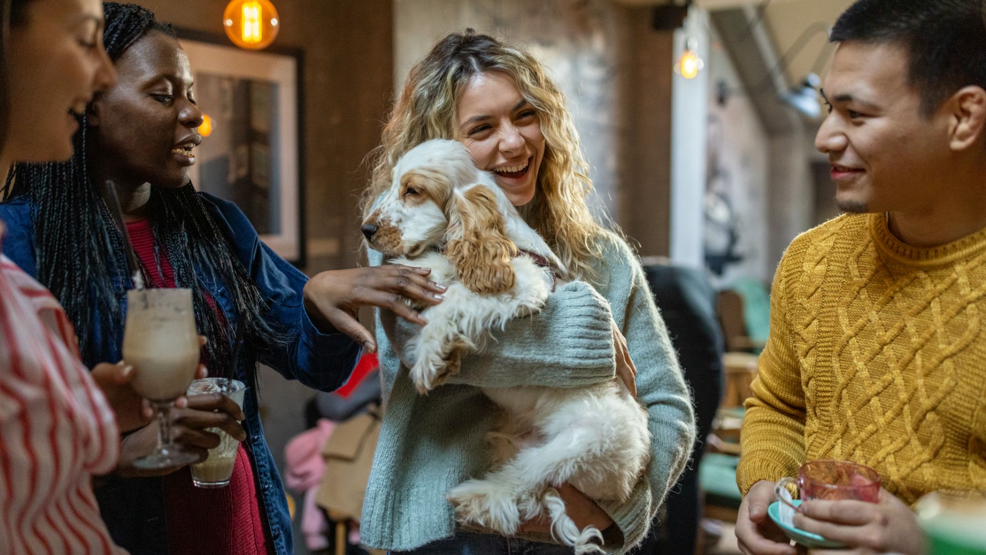 woman with her friends holding her cocker spaniel
