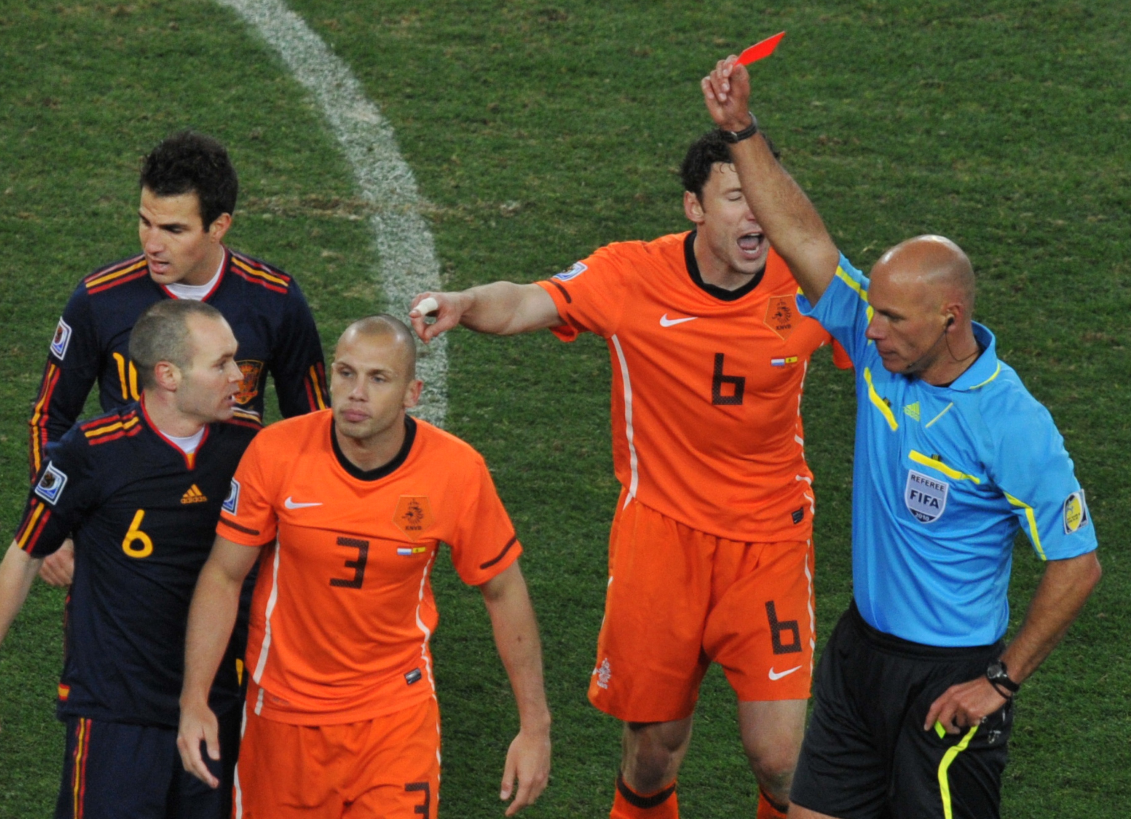 The Netherlands' John Heitinga (wearing the number 3) is sent off by referee Howard Webb in the 2010 World Cup final against Spain.