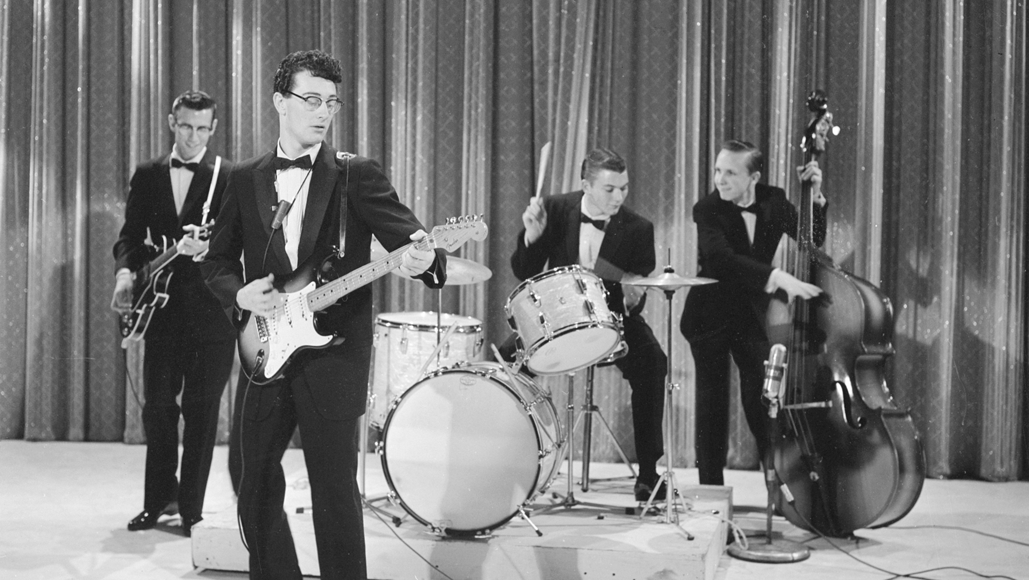 Buddy Holly and the Crickets perform on Ed Sullivan's CBS variety show 'Toast of the Town,' New York, December 1, 1957. The Crickets were (left to right) rhythm guitarist Niki Sullivan (1937 - 2004), drummer Jerry Allison, and bassist Joe B. Mauldin.
