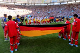 Flag bearers hold the Germany flag during the national anthems ahead of the World Cup final between Germany and Argentina in Brazil in July 2014.