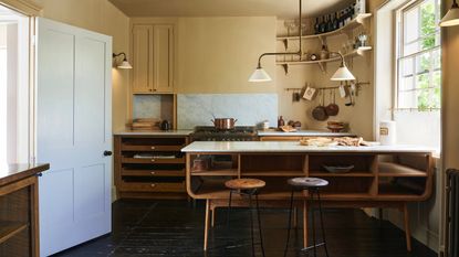 can you fit an island into a galley kitchen, yellow kitchen with freestanding units, hanging rails, stools, white countertops