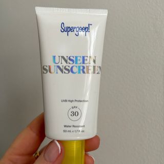 Laura holding Supergoop! Unseen Sunscreen SPF 30 - best sun creams
