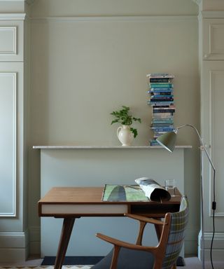 desk area with stack of books and chair