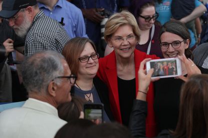 Elizabeth Warren poses with voters.