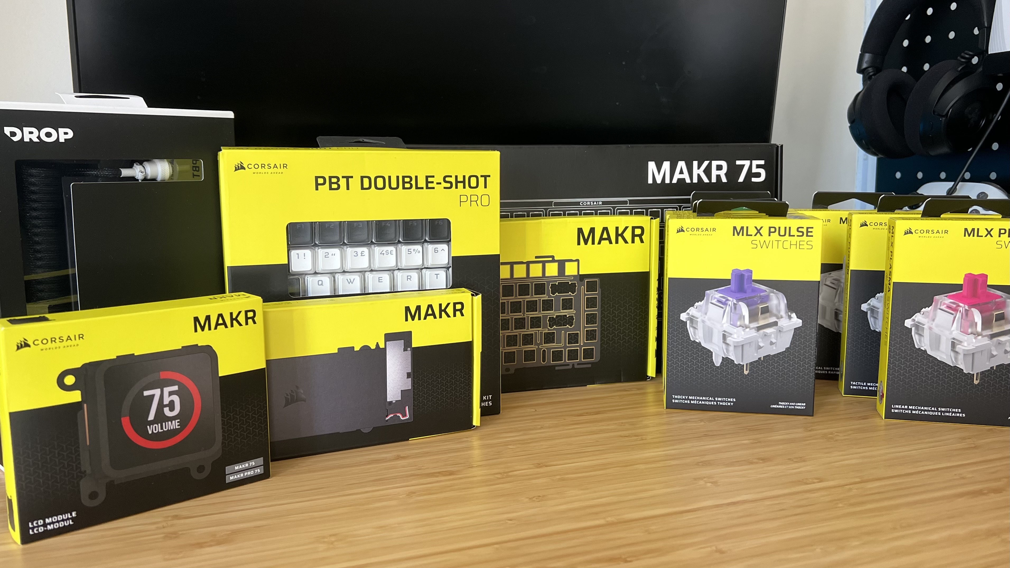Corsair MAKR 75 accessories and keyboard on a wooden desk