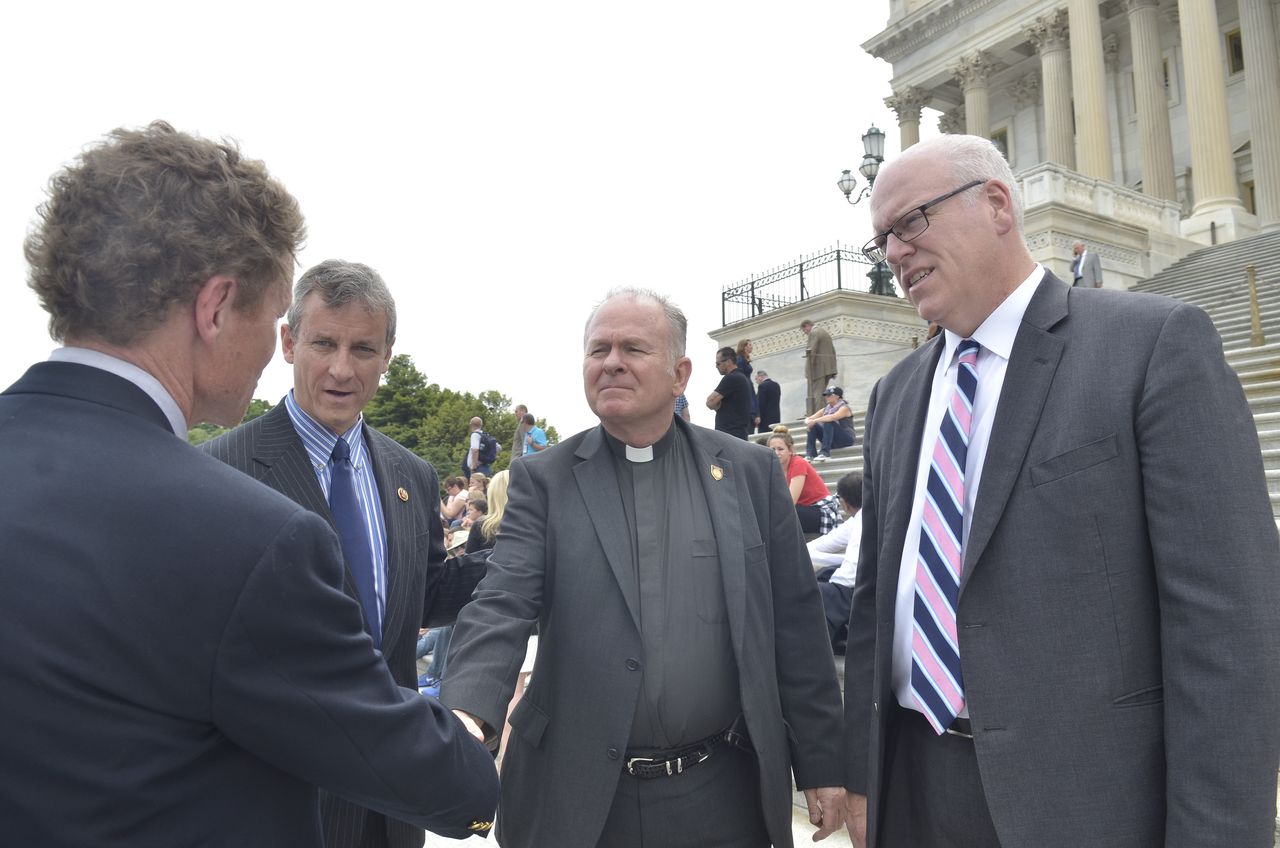 Rev. Patrick J. Conroy with House members.